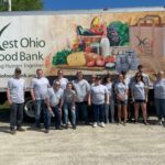 People standing in front of a food bank truck