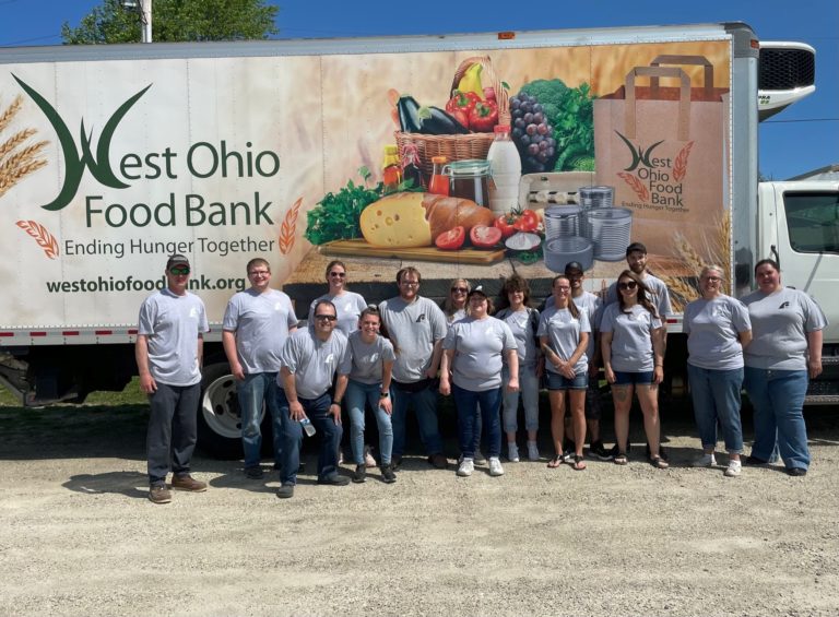 People standing in front of a food bank truck
