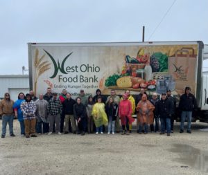 Volunteers standing in front of food pantry truck